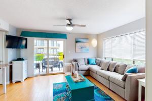 a living room with a couch and a table at Outrigger 114 in Ocean City