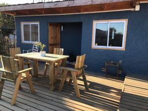 a wooden table and chairs on a deck at 100 Experiencias Chile, habitación 3 in Lagunillas