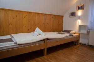 a bedroom with a bed with a wooden wall at Chalet Lana with Hot Tub in Gozd Martuljek