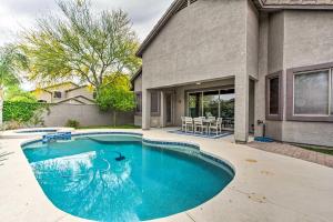 a swimming pool in front of a house at Bright Phoenix Home with Private Pool and Hot Tub in Anthem