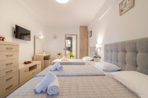 a bedroom with two beds and a dresser at Villa En Elladi in Alikanas +36 photos