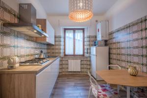 a kitchen with a white refrigerator and a table at Entro le mura in Montepulciano