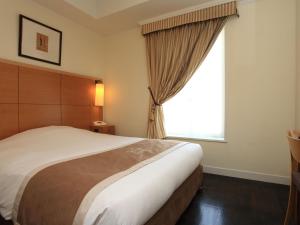 Postel nebo postele na pokoji v ubytování Hotel Monterey Lasoeur Ginza