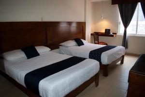 Postel nebo postele na pokoji v ubytování Hotel Casa Blanca