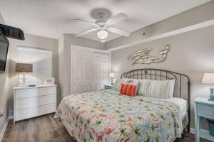 a bedroom with a bed and a ceiling fan at Fourwinds 803 - Beachfront condo w/ Hall Bunks! - Elevator replacement 4/4-5/24 in Orange Beach