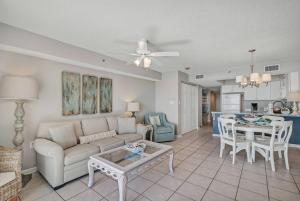 a living room with a couch and a table at Fourwinds 803 - Beachfront condo w/ Hall Bunks! - Elevator replacement 4/4-5/24 in Orange Beach