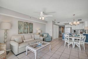 a living room with a couch and a table at Fourwinds 803 - Beachfront condo w/ Hall Bunks! - Elevator replacement 4/4-5/24 in Orange Beach