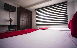 Voodi või voodid majutusasutuse Hotel Bogotá Real toas