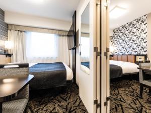 Ένα ή περισσότερα κρεβάτια σε δωμάτιο στο APA Hotel Namba Shinsaibashi Higashi