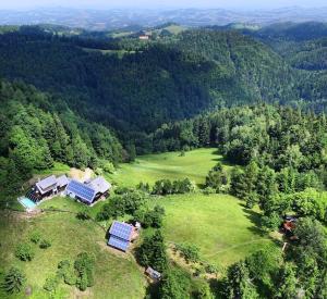 an aerial view of a house with solar panels on a field at Treehouse Toplak in Ruše
