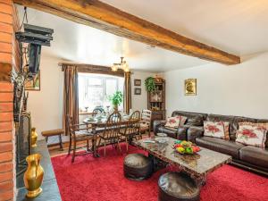 a living room with a couch and a table at Halfen Granary in Llanfihangel-yng-Ngwynfa