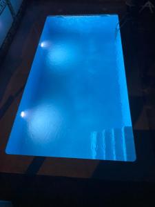 a blue pool of water with lights in it at Casa con Piscina cerca de la playa in Baiona