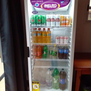 an open refrigerator filled with drinks and drinks at Amambay Apart &Suites in Eldorado