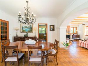 a dining room with a table and chairs at Belvilla by OYO Embat de Mar in Son Servera