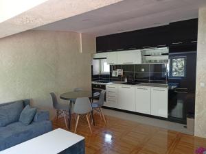 a kitchen and living room with a table and chairs at Tina in Užice