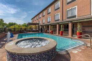 a swimming pool in front of a building at Best Western Plus DFW Airport Suites in Irving