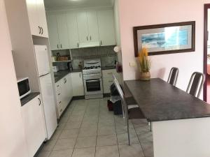 a kitchen with white cabinets and a table with chairs at Eagle Bay Views in Eagle Point