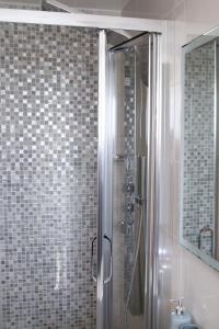 a shower with a glass door in a bathroom at Exclusive Ensuite Double Room in London