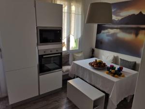 a kitchen with a table with a bowl of fruit on it at Lovely lake wiev&pool in Malcesine