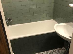 a bathroom with a white bath tub next to a sink at Ferienhaus in Willingen nahe Skipisten in Willingen