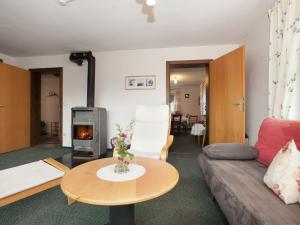 a living room with a couch and a fire place at Cosy and spacious apartment with balcony in the Black Forest in Waldachtal
