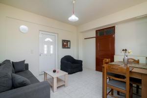 a living room with a couch and a table at En Elladi Apartment in Alikanas