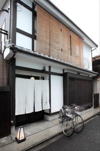 a couple of bikes parked in front of a building at Kyoto Guesthouse Roujiya in Kyoto