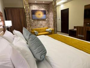 a bedroom with a large bed with white pillows at Moments in Jeddah