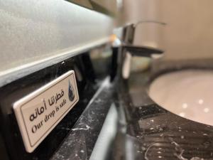 a close up of a toaster oven with a sink at Moments Hotel in Jeddah