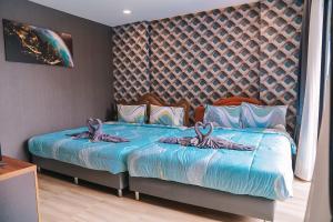Cama ou camas em um quarto em The Blue Mountain Pool Villa Cha-am
