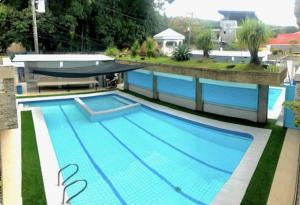 a large swimming pool on top of a building at Villa Leah Natural Hotspring Resort in Calamba