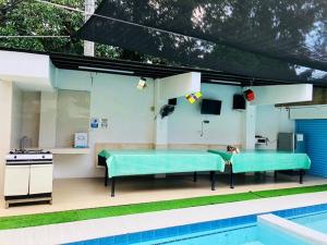 a swimming pool with a table next to a swimming poolasteryasteryasteryasteryastery at Villa Leah Natural Hotspring Resort in Calamba