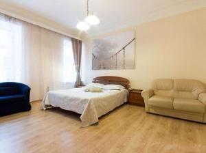 a bedroom with a bed and a couch and a bridge at Home Center Kiev Apartments in Kyiv