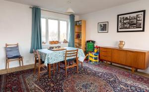 a dining room with a table and chairs in a room at Marie's Cottage, Pagham in Pagham