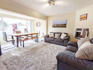 a living room with a couch and a table at Bankside, Middleton in Middleton-on-Sea