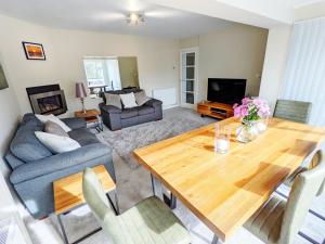 a living room with a table and a couch at Bankside, Middleton in Middleton-on-Sea