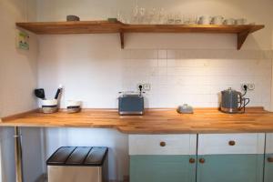 a kitchen with a wooden counter top in a kitchen at Ferienwohnung am Schwimmbachtal in Georgenthal