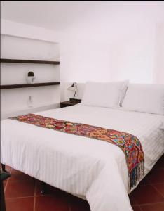 a bedroom with a large white bed in a room at Villa Santa Inés in Antigua Guatemala