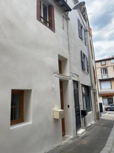 a white building with a mailbox on the side of it at Joli studio calme et lumineux in Royat
