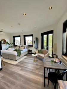 a bedroom with a bed and a living room at Boutique Hotel LE•BAR in Zandvoort +46 photos