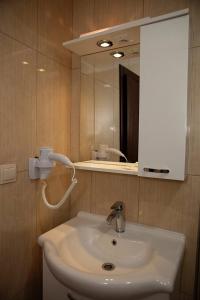 a bathroom with a white sink and a mirror at Can Apartments in Turunç