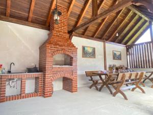 a brick fireplace in a dining room with a table at Absolut Residence Hateg in Haţeg