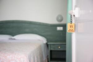 Posteľ alebo postele v izbe v ubytovaní Albergo Villa Mario