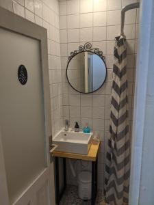 a bathroom with a sink and a mirror at Small cozy apartment near the center of Plovdiv in Plovdiv