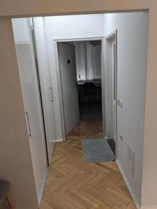 a hallway leading into a room with a mirror at Small cozy apartment near the center of Plovdiv in Plovdiv
