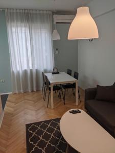 a living room with a table and a couch at Small cozy apartment near the center of Plovdiv in Plovdiv