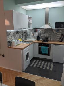 a kitchen with a washer and a washing machine at Small cozy apartment near the center of Plovdiv in Plovdiv