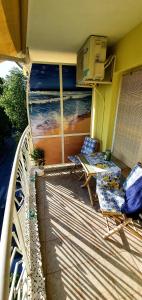 a balcony with two chairs and a view of the ocean at Mommy's House in Varna City