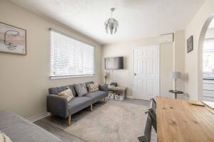 a living room with a couch and a table at Windsor Burnham Ascot Haven Sleeps 4 in Slough