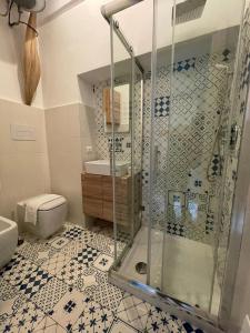 a bathroom with a shower and a toilet at Petit Maison Jeranto in Nerano
